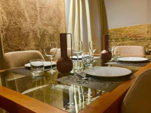 a dining table with wine glasses and plates on it at Allegretto Rialto in Venice
