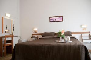 Postel nebo postele na pokoji v ubytování Albergo La Rosetta