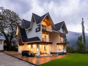 a house with a car parked in front of it at Moustache Pahalgam in Pahalgām +41 photos