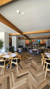 a dining room with wooden tables and chairs at Arkhi Kokhta Bakuriani Apt 304 in Bakuriani