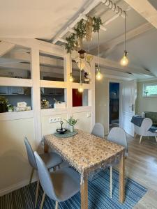 a dining room with a table and chairs at Ferienhaus am See in Staupitz