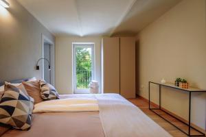 a bedroom with a large bed and a window at Villa Immersa Tra Le Vigne Con Piscina Riscaldata in Castiglione Tinella +37 photos