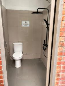 a bathroom with a white toilet in a stall at Luxury Camp Waduk Darma in Haurkuning