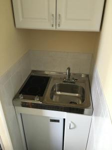 a kitchen with a sink and a stove at Gulfview Hotel - On the Beach in Clearwater Beach