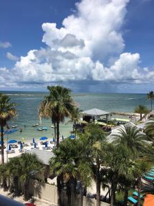 a beach with palm trees and people in the water at Gulfview Hotel - On the Beach in Clearwater Beach