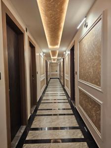 a corridor in a building with a hallway at Hotel Cedara in Haldwāni