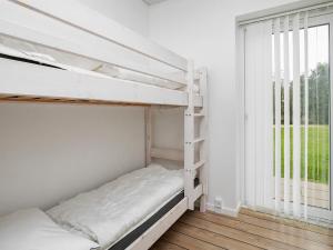 a white bunk bed in a room with a window at 5 star holiday home in Ringkøbing in Ringkøbing +23 photos