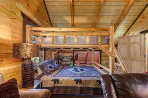 a room with a loft bed in a log cabin at Makin' Memories- Cabin-near Dollywood, w Hot Tub, Game Loft, Fire Pit & Peaceful View-FREE Tickets in Sevierville