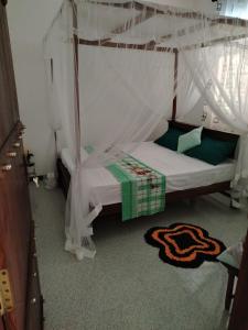 a bedroom with a bed with a canopy at Family Home Unawatuna in Unawatuna