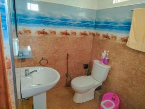 a bathroom with a toilet and a sink at Family Home Unawatuna in Unawatuna