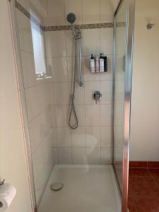 a shower with a glass door next to a sink at Guest suite in Phillip Island in Cape Woolamai +13 photos