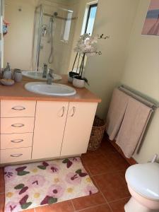 a bathroom with a sink and a toilet at Guest suite in Phillip Island in Cape Woolamai