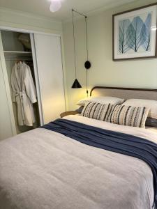 a bedroom with a large bed and a closet at Guest suite in Phillip Island in Cape Woolamai
