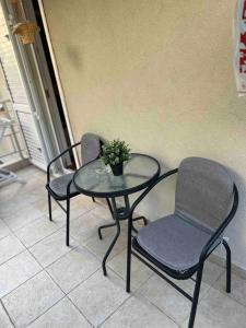 two chairs and a table with a plant on it at Maya bay in Kotor