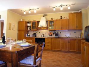 a kitchen with a wooden table and a dining room at Villa in Tuscany with pool in Loro Ciuffenna