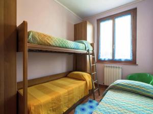 a bedroom with two bunk beds and a window at Villa in Tuscany with pool in Loro Ciuffenna