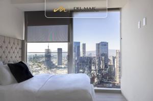a bedroom with a bed and a large window at Lobby 33 in Guadalajara +67 photos