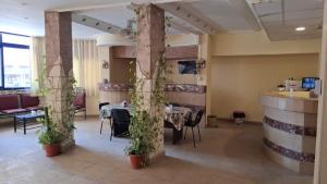 a dining room with a table with plants on it at Canary Hotel in Hurghada