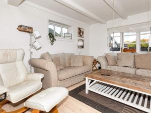 a living room with white furniture and a piano at 6 person holiday home in Skagen in Skagen +20 photos