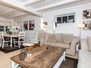 a living room with a couch and a table at 6 person holiday home in Skagen in Skagen