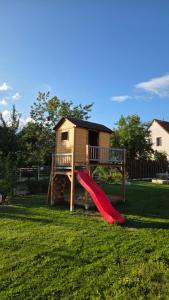 a playground with a slide and a house at Apartmány Branná 31 Třeboň in Třeboň