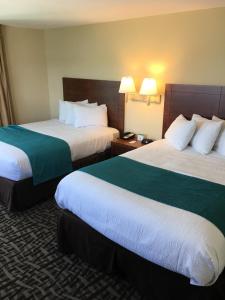 a hotel room with two beds with green and white sheets at Gulfview Hotel - On the Beach in Clearwater Beach