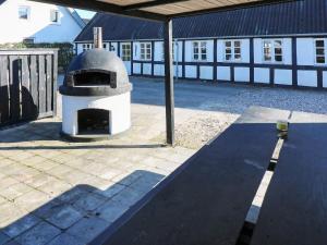 a pizza oven sitting in the middle of a patio at 10 person holiday home in Hadsund in Hadsund