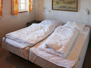 an unmade bed in a room with a window at 4 star holiday home in Hadsund in Hadsund