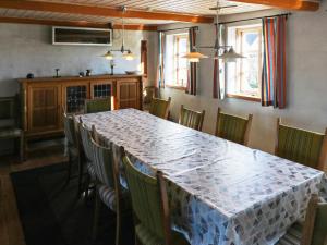a dining room with a long table and chairs at 4 star holiday home in Hadsund in Hadsund