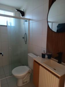 a bathroom with a toilet and a sink and a mirror at Refúgio com Lazer de Resort in Estância
