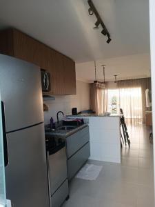 a kitchen with a refrigerator and a counter top at Refúgio com Lazer de Resort in Estância