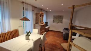 a living room with a white table and a couch at Ciasa Rungger in San Martino in Badia