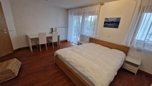 a bedroom with a bed and a table with chairs at Ciasa Rungger in San Martino in Badia +22 photos
