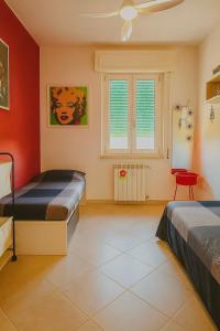 Ένα ή περισσότερα κρεβάτια σε δωμάτιο στο Sea la Vie Apartment - Orbetello