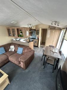 a living room with a couch and a table at The Lake District Caravan in Lamplugh