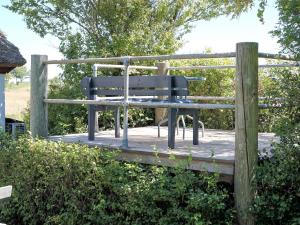 a park bench sitting on a wooden deck at 6 person holiday home in Vesløs-By Traum in Øsløs