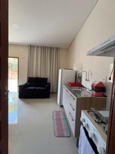a kitchen with a stove and a refrigerator at Recanto Mandacaru in Queimada +9 photos
