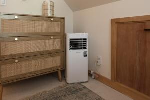 a small refrigerator in a room next to a dresser at Cozy Chic Alpine Suite with AC - Walk to Lake in Tahoe City