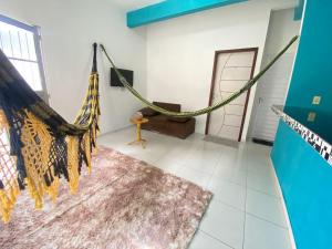 a room with a hammock in a room at Recanto Buriti in Barreirinhas