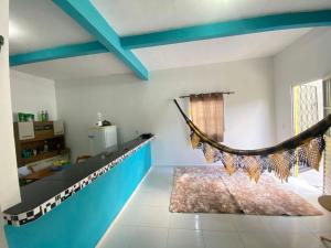 a room with a hammock hanging from the ceiling at Recanto Buriti in Barreirinhas