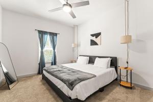 Adeline Apartments 15m to Parks, Pet Friendly, Free Parking by Heavenly Homes في أورلاندو: غرفة نوم بها سرير ومروحة سقف