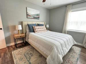 a bedroom with a large bed and a window at Restful Retreat with 4 Beds Sleeps 6 in Valdosta