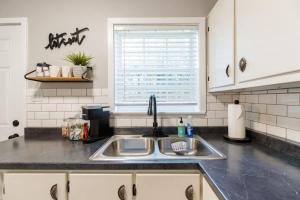 a kitchen counter with a sink and a window at Restful Retreat with 4 Beds Sleeps 6 in Valdosta