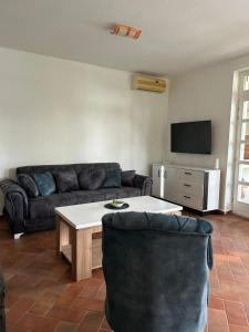a living room with a couch and a table at Villa Ela in Prijedor
