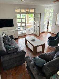 a living room with couches and a coffee table at Villa Ela in Prijedor