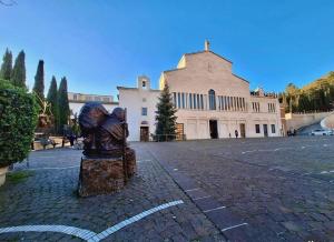 a statue of a person on a street in front of a building at Hotel San Francesco in San Giovanni Rotondo
