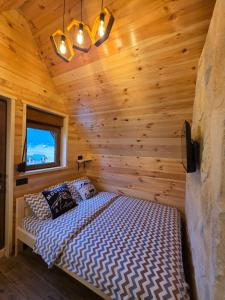 a bedroom with a bed in a log cabin at Mountain Peace in Žabljak