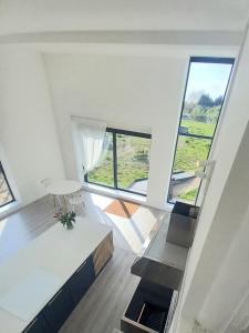 an empty living room with a large window at The Dutch Barn in Maidstone