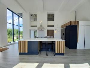 a kitchen with blue and white cabinets and a counter at The Dutch Barn in Maidstone
