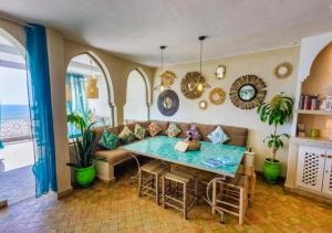 a living room with a table and a couch at Dar Mogador Océan near Taghazout - Surf, colorful village in Taghazout